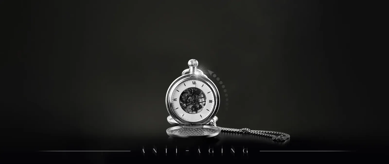 Silver pocket watch on a dark background
