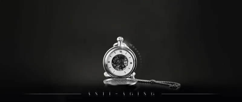 Silver pocket watch on a dark background