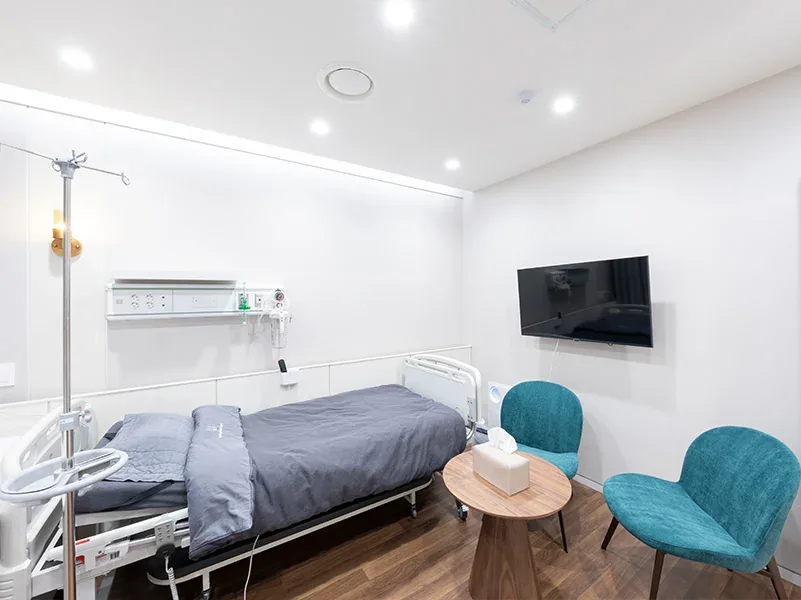 Recovery room with a hospital bed and an IV stand