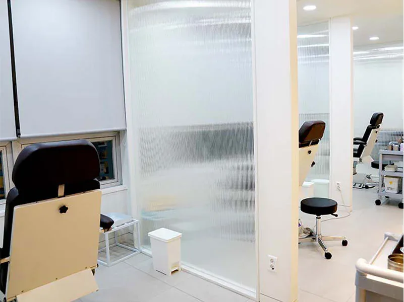 Treatment booths with reclining chairs and glass partitions