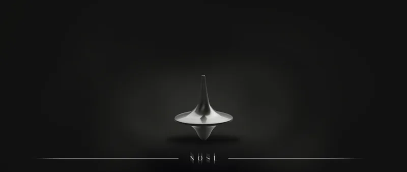 Silver spinning top on a dark background
